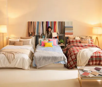 Room planning specialist arranging bedding samples